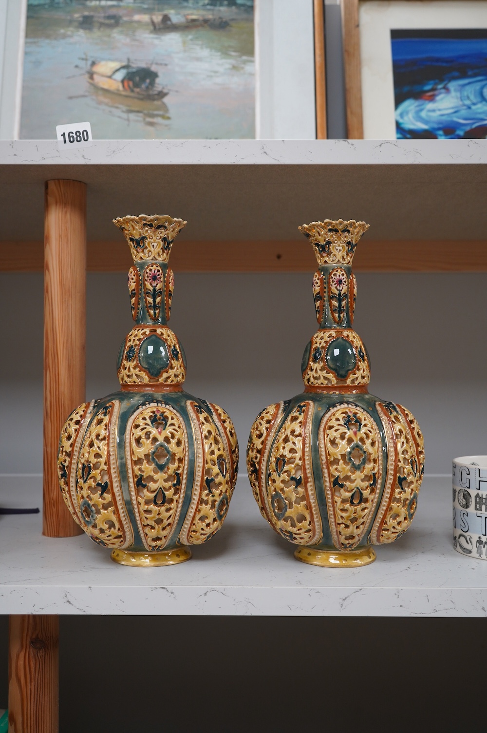 A pair of Zsolnay, Hungarian double walled reticulated vases, 29cm high. Condition - some restoration